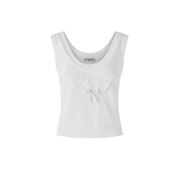 A white sleeveless knit crop top featuring a textured waffle knit body, a scoop neckline, and a 3D knitted butterfly embellishment on the chest with a small pearl accent.